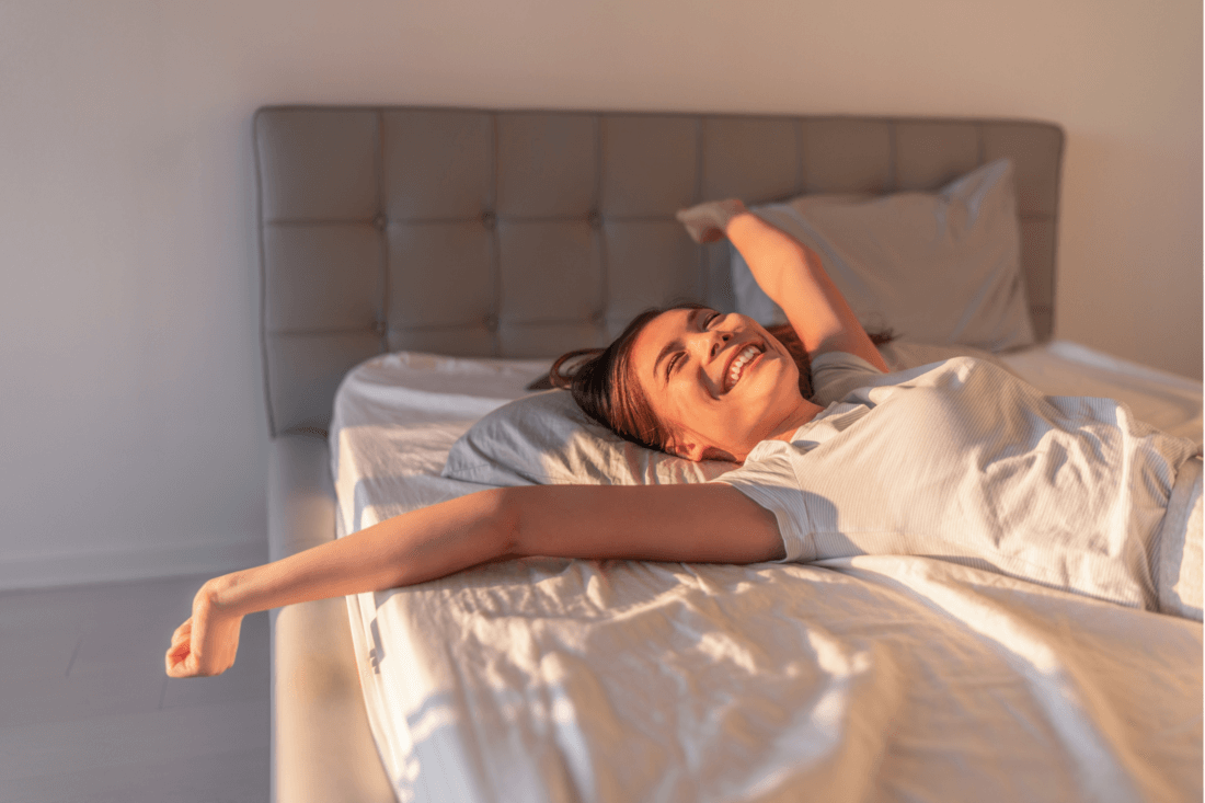 Happy woman waking up in the sun, sunlight regulates our sleep cycle
