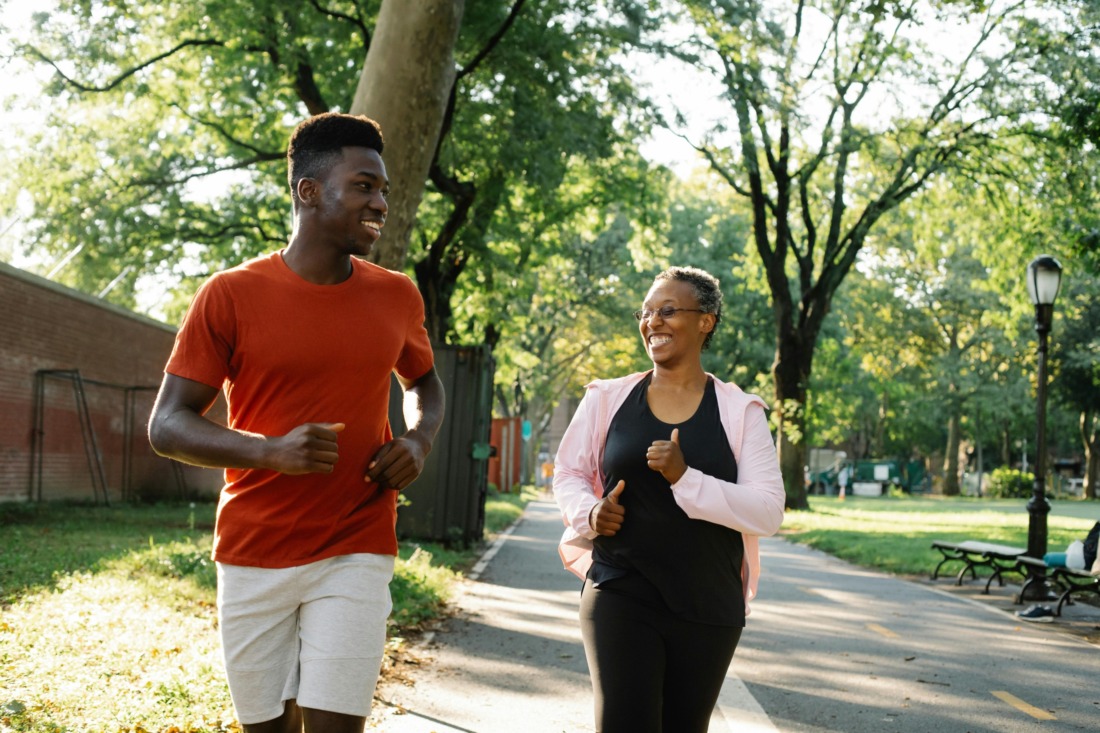 energetic people running in the sun outdoors